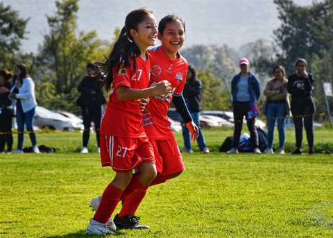 Girls playing soccer on oval.jpg