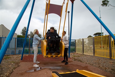 Boy enjoying a liberty swing at a playground