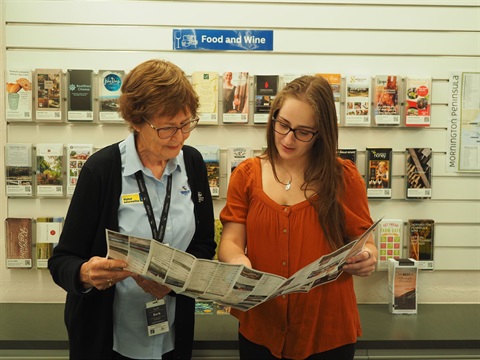 Volunteer showing map to customer 
