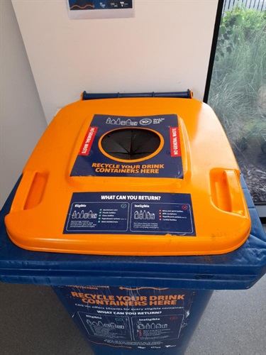 photograph of blue wheelie bin with orange lid