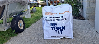 image of white Bulka Bag with text 'return it' written on the front in blue