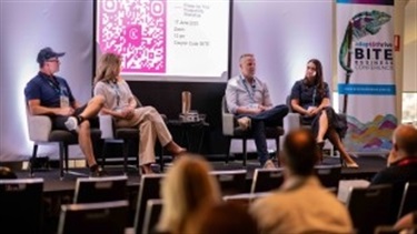 4x Panellists discussing their top on stage