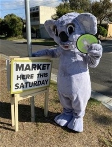 Cribby Koala with market sign